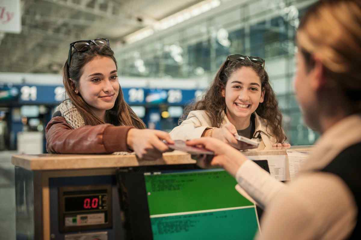 Two teenage girls at airport check-in area