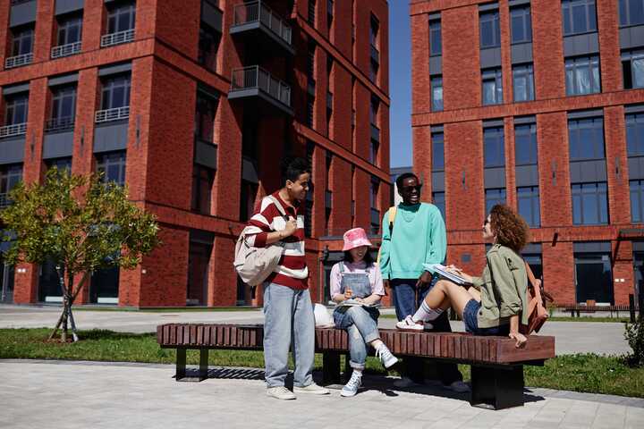 Diverse group of students studying together outdoors
