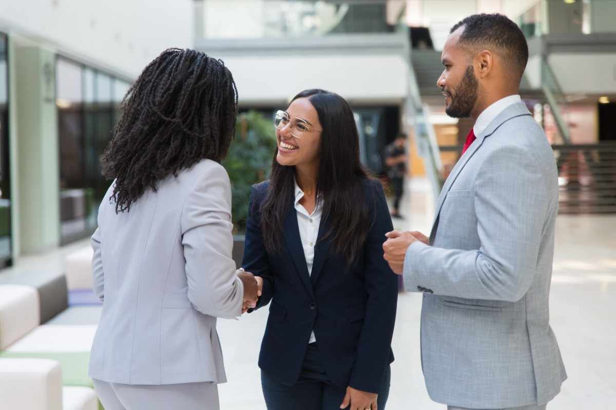 Group of diverse business partners shaking hands