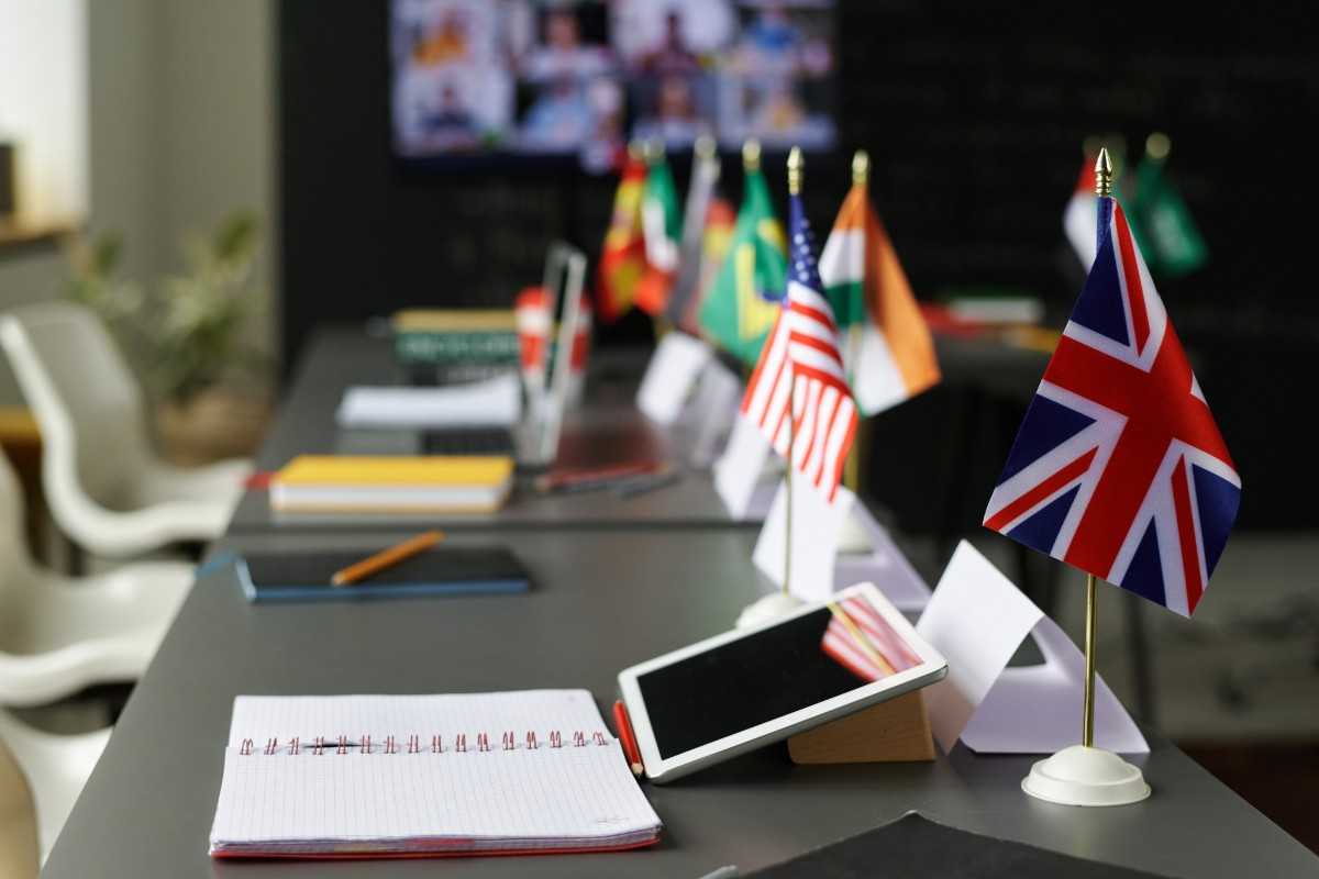 A table with different flags placed on top in a classroom