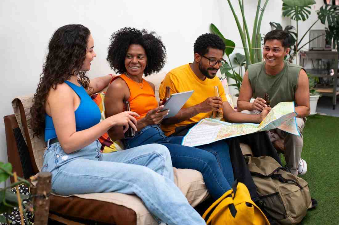 Young people sitting in front of a hostel