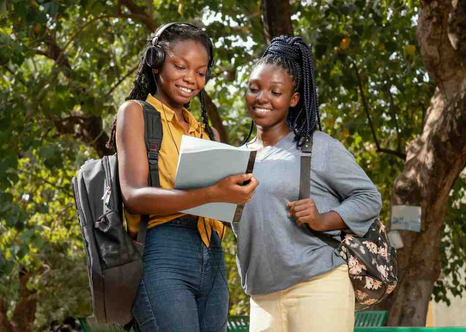 Girls looking at a notebook