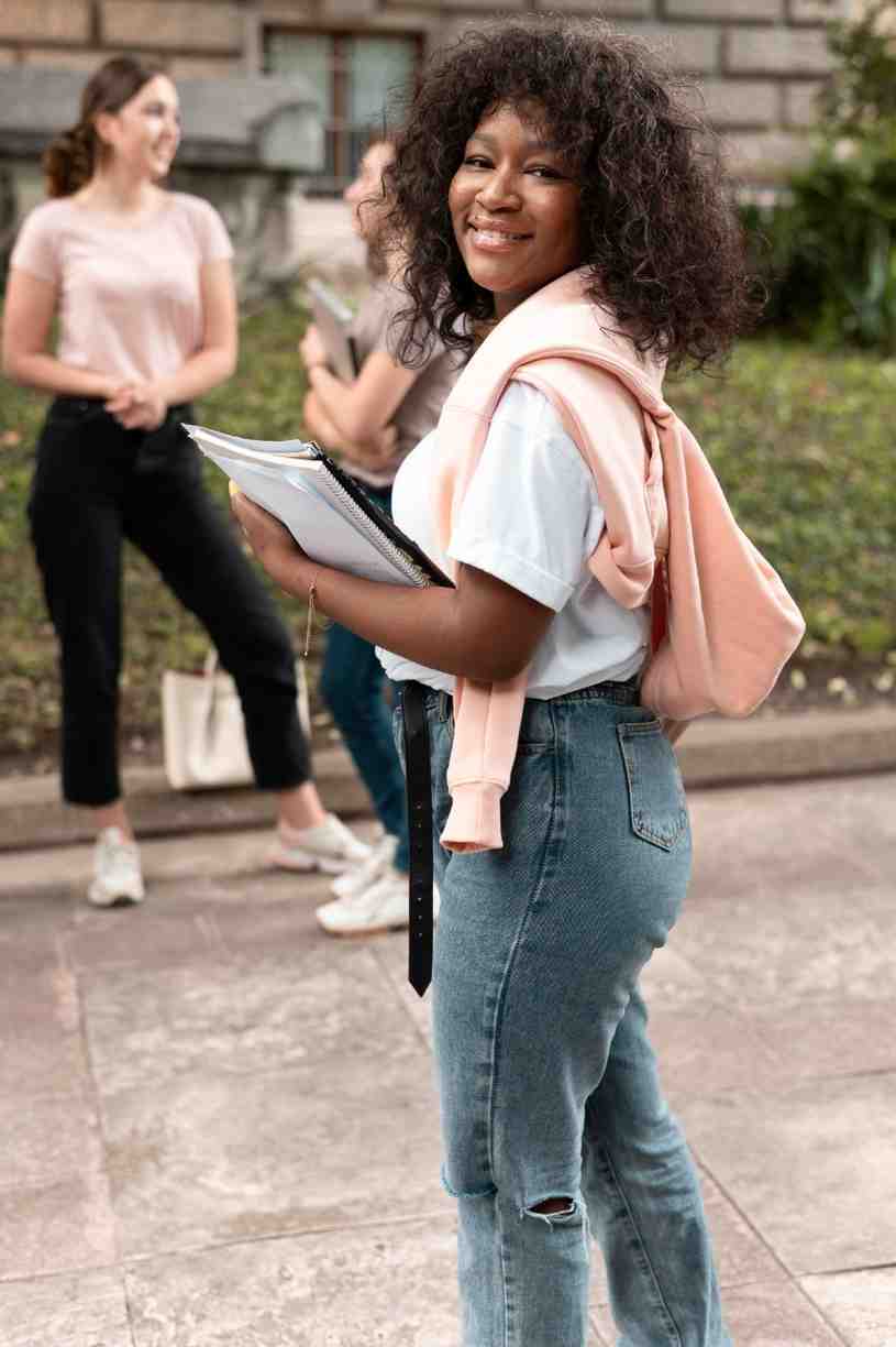 African-american girl with her books on campus
