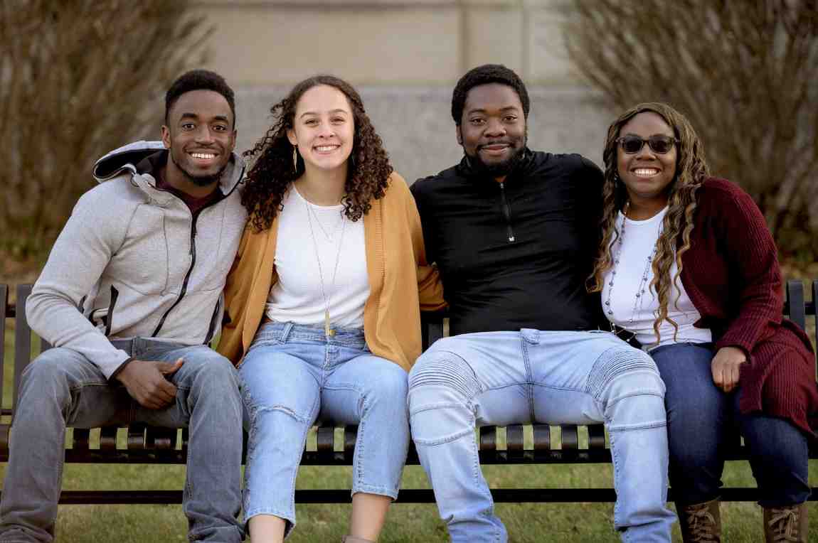 Group of people sitting in a bench park