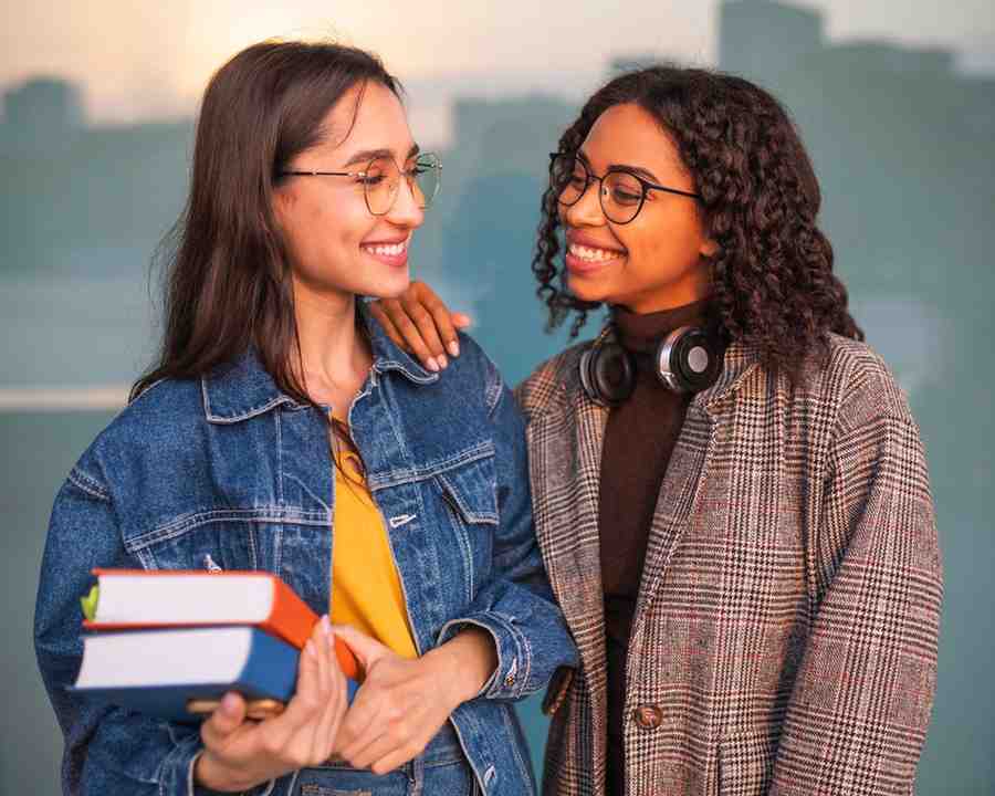Smiley friends posing together with books