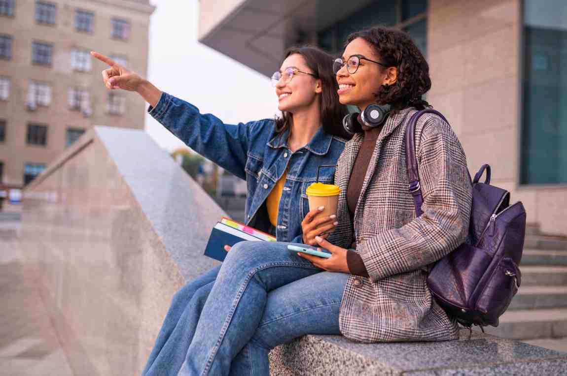 Smiley friends with books having coffee together