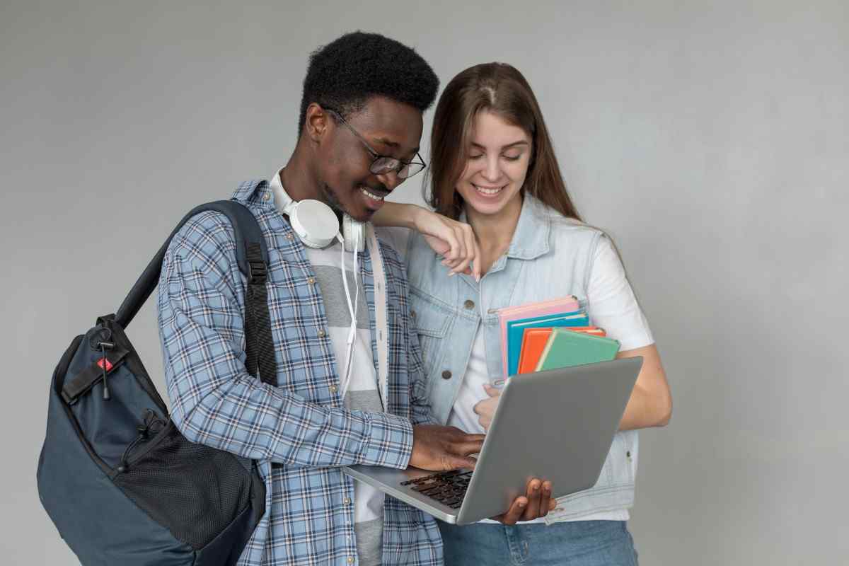 Two students having a discussion on something in a laptop
