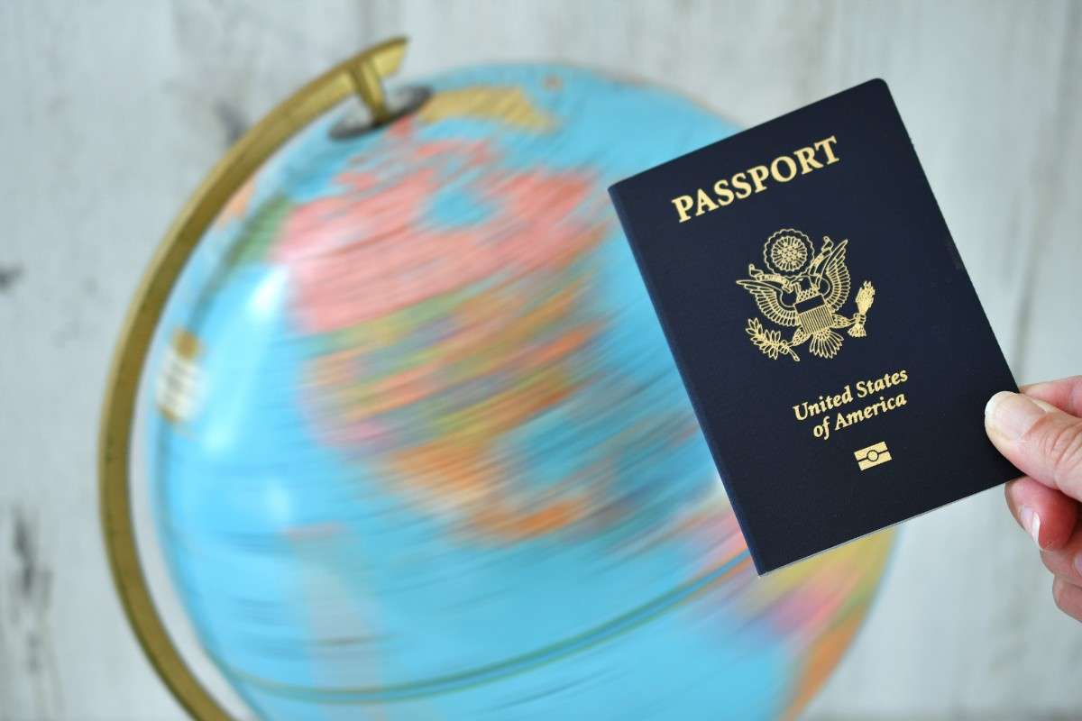 Picture of a united states of america passport with a spinning globe behind